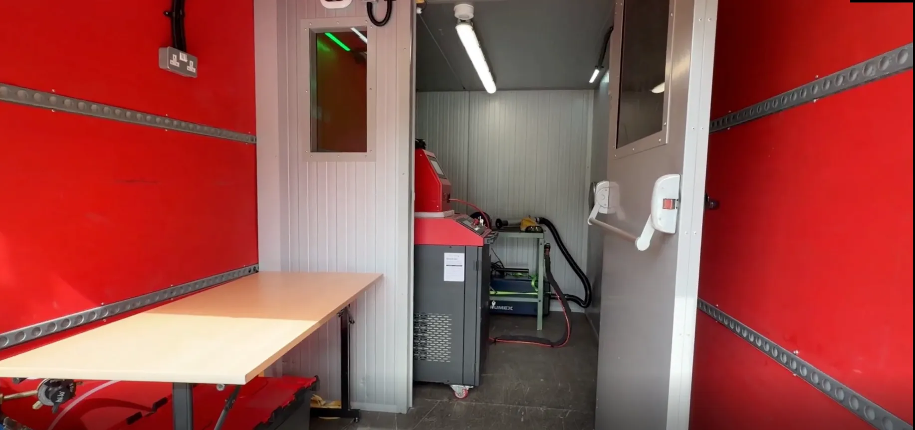 The fitted-out van interior — bench, enclosure and extraction.